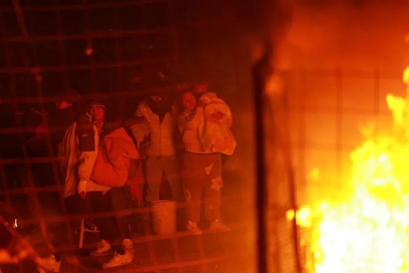 Migrants set fire to a camp in Mexico in an attempt to evade mass arrests.